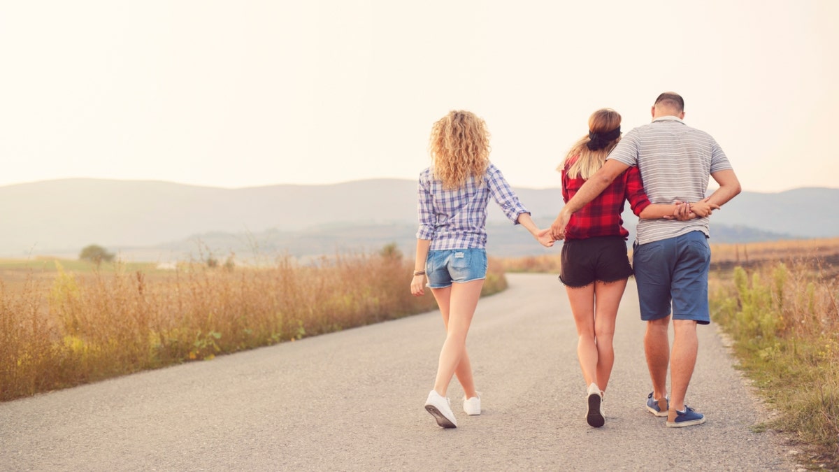 Photo of polyamorous throuple