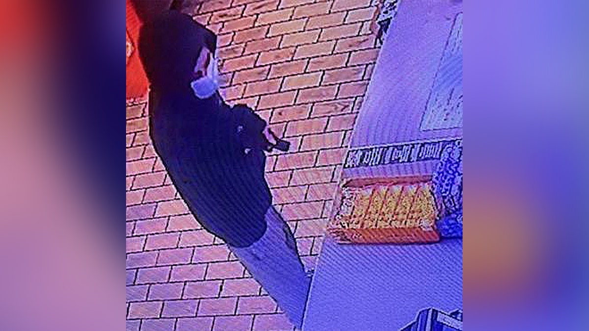 man appears armed at cashier of convenience store