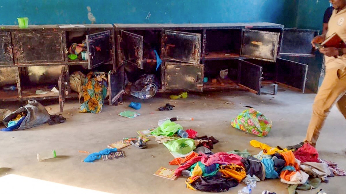 Man walks past belongings of abducted children