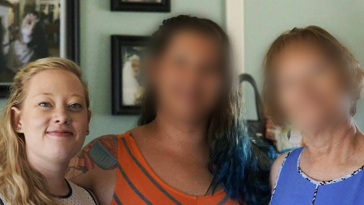 Renee Nicole Good stands with two others