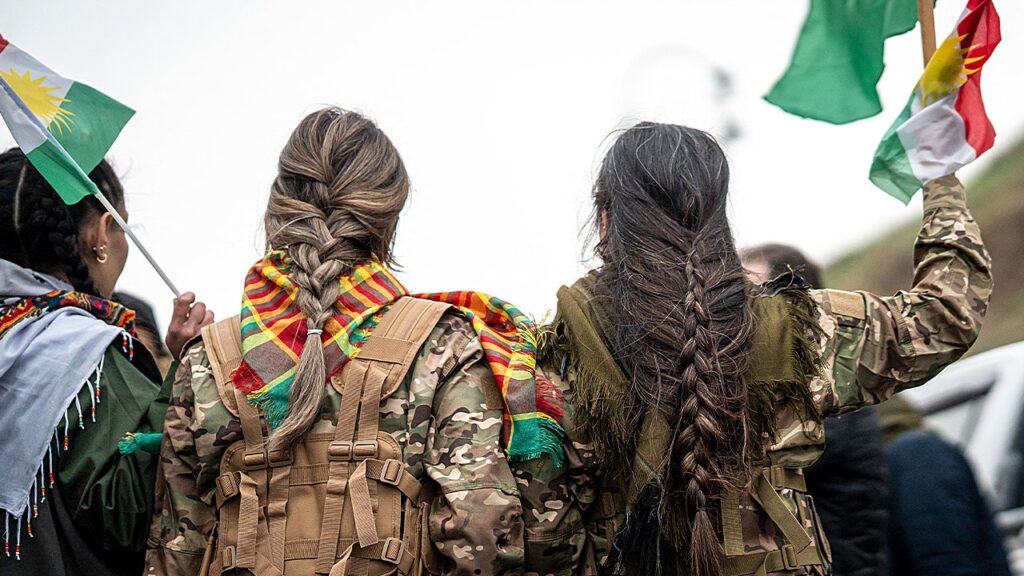 Syrian militiaman shows off what he claims to be severed Kurdish fighter’s braid as Damascus asserts control