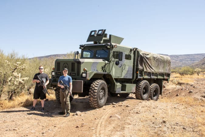 The owner and son proudly show off their Blackout Dynamics rifles.